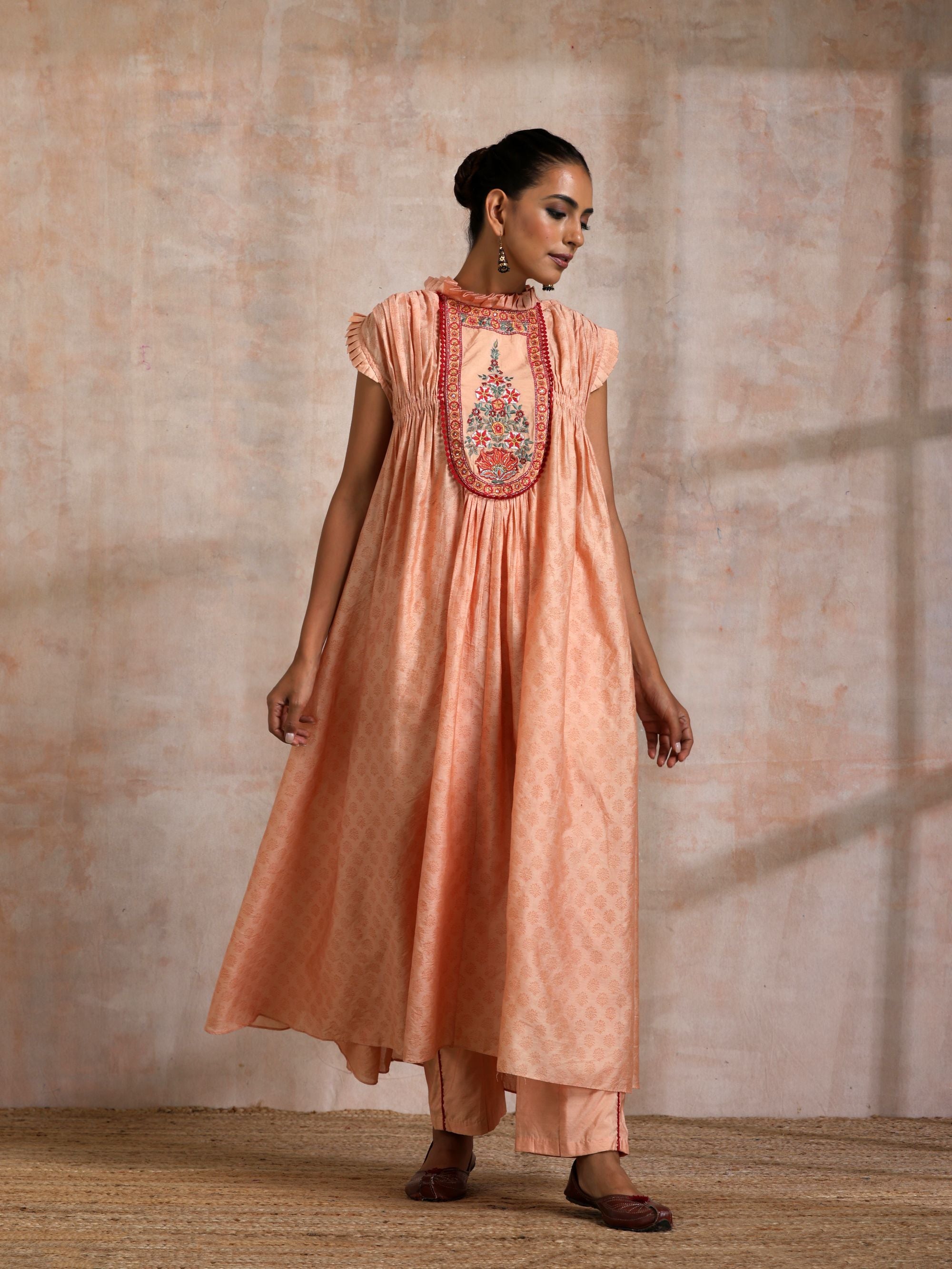 KESARI CHANDERI CHOGA WITH EMBROIDERED YOKE FRILLED COLLOR AND SLEEVES