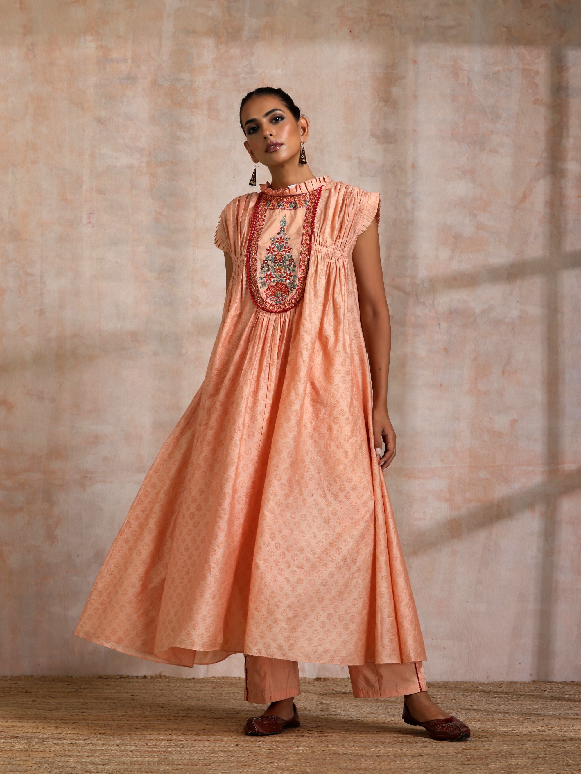 KESARI CHANDERI CHOGA WITH EMBROIDERED YOKE FRILLED COLLOR AND SLEEVES